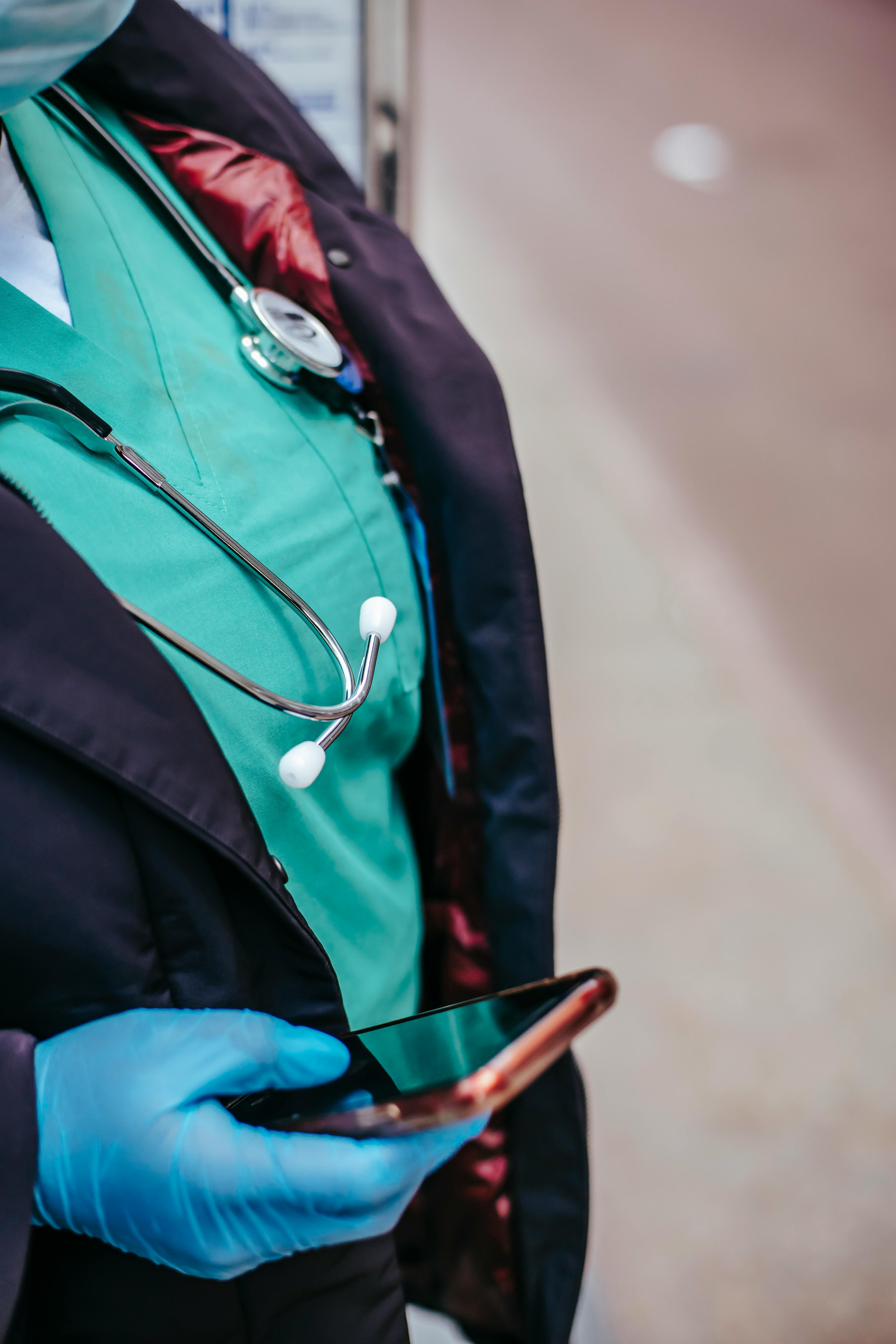 Healthcare worker in gloves using a phone, healthcare automation by ReIntellex
