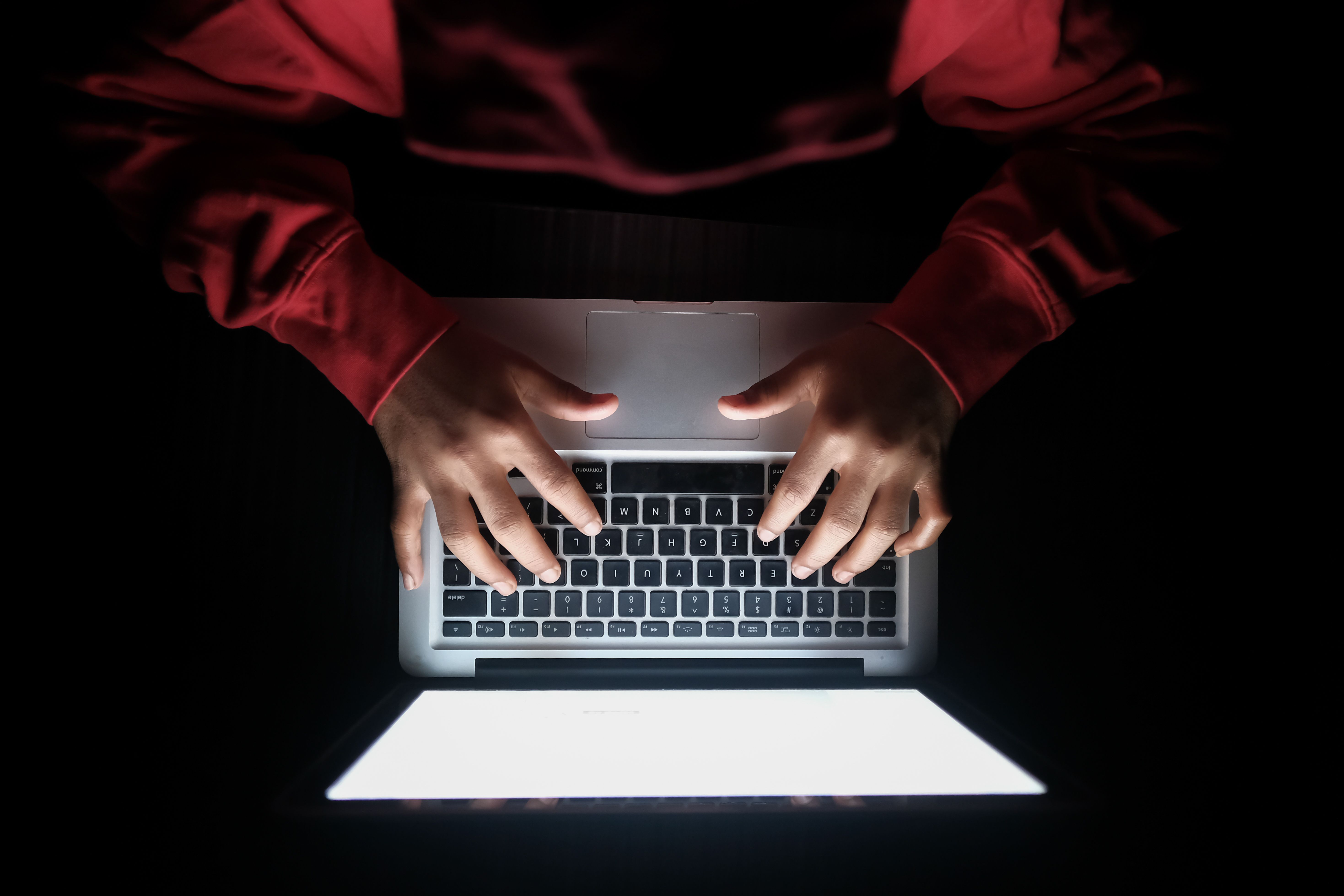 Hands deploying a live automation on a laptop
