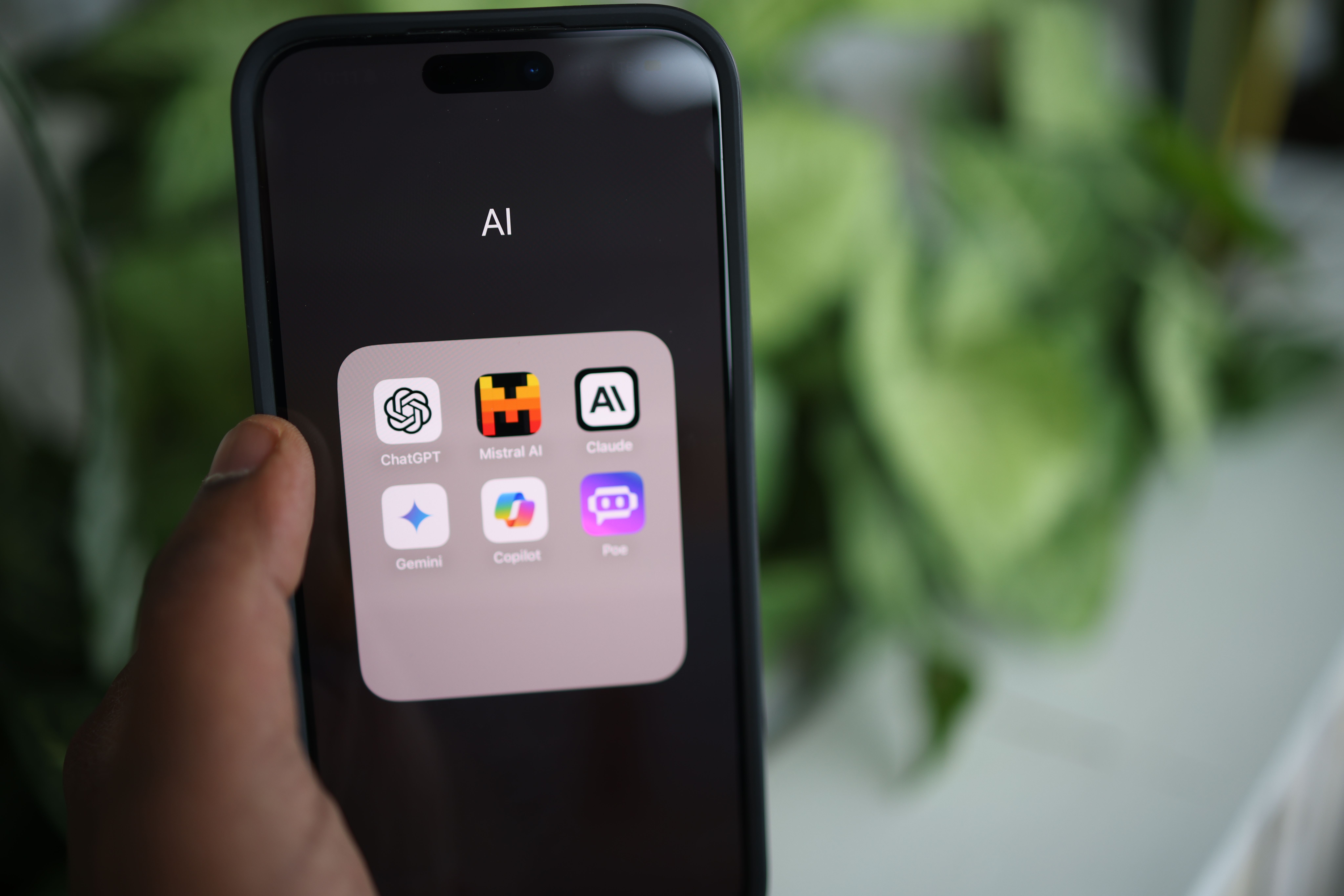 Hand holding a phone of AI apps used in ReIntellex automation and AI training